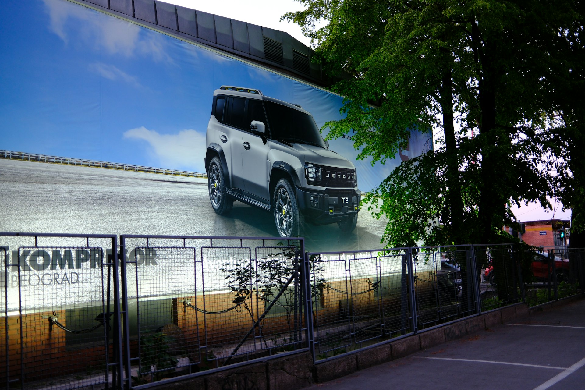 White suv advertisement on a large building facade